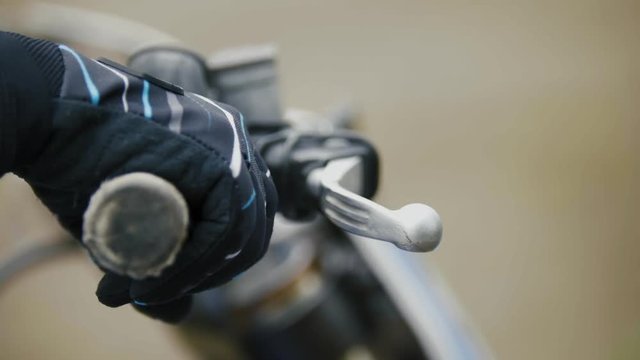 Cross motorcycle engine start. MX, close up shot of hand on handlebar