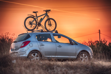 Car is transporting bicycle on the roof