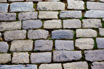 Fragment of old cobblestone road , the cobblestones