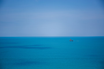 The boat in the azure ocean