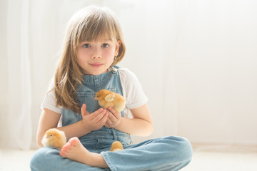 Young beautiful girl, playing with little newborn chick at home © Tomsickova