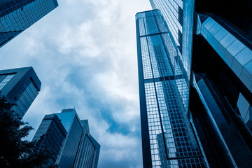 Fototapeta na wymiar low angle view of modern metallic skyscrapers,blue toned,suzhou,china.