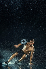 Water drops around football player under water