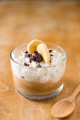 Banoffee pie in glass cup on table.
