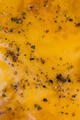 Yellow scrambled eggs with pepper, close up, background