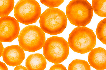 Heap fresh slices carrot isolated on white background. Decorative art food background.