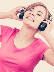 Naklejka premium Woman in big headphones listening music