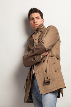 young attractive man in a trench rain coat