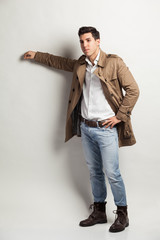 young attractive man in a trench rain coat