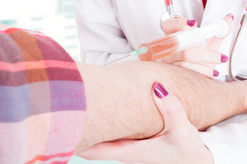 Close-up of woman doctor giving an injection