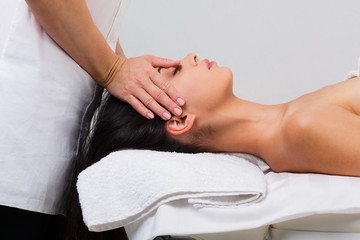 Fototapeta premium Woman massagist make face lifting massage in spa wellness center
