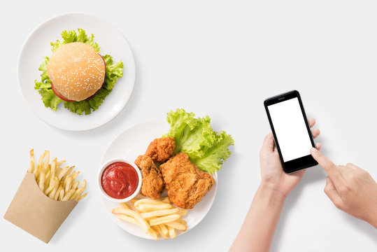 Design concept of mockup Using smartphone with burger, french fries, fried chicken set isolated