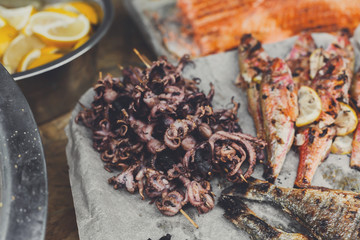 Seafood, fish, octopus grilled at barbecue
