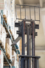 Obraz premium warehouse stacker forklift lifting