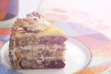 Delicious piece of cake on a plate. Toned