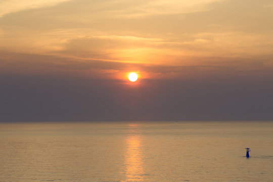 sunrise over calm sea   in warm tone