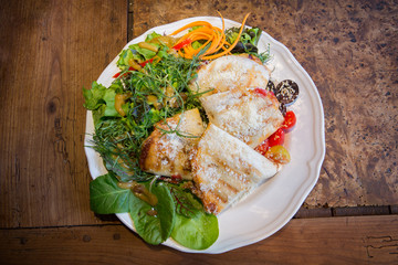 Focaccia slices with parmesan and salad