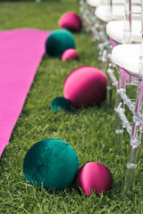 Green and violet cloth balls lie along the path to wedding altar