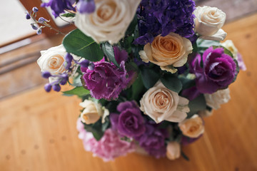 White roses and violet flwoers decorate a pillar