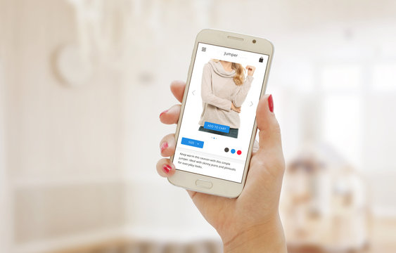 Modern shopping app on smart phone in the women hand. Buying clothes on web site or app.