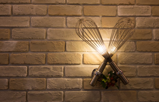 Whisk lamp on brick wall with copy space