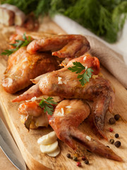 Grilled chicken wings on board. Food concept