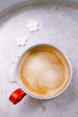 coffee in unusual vintage tin mug with red handle
