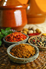 Dried red, hot chili, black, white peppers in old clay bowls 