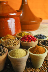 Collection of different spices in old clay bowls in colorful oriental style
