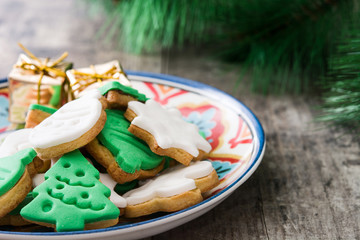 Christmas cookies a plate in on a rustic wooden background

