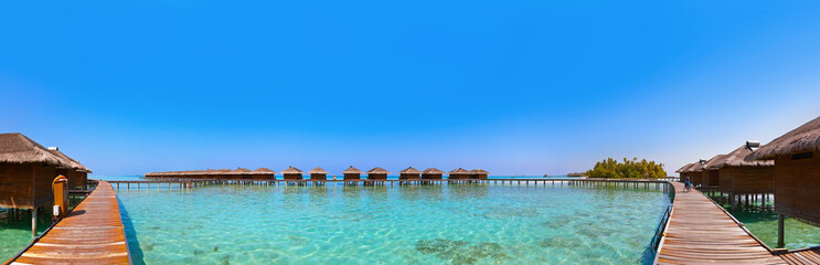 Bungalows on tropical Maldives island
