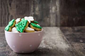 Christmas cookies in a bowl on wooden background

 - obrazy, fototapety, plakaty