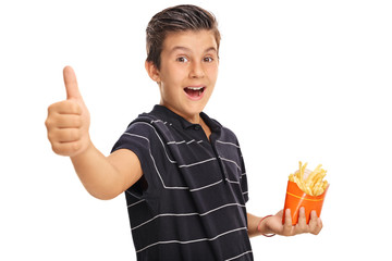 Boy giving a thumb up and holding a bag of fries