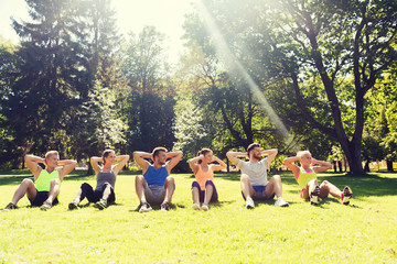 group of friends or sportsmen exercising outdoors