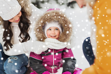 happy family with child in winter clothes outdoors