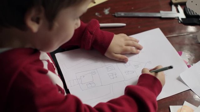Boy Draws a Picture House, the Family, Sitting at the Table