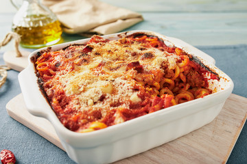 Baked anelletti pasta with mince, sauce and mozzarella. Typical sicilian dish