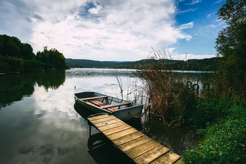 Peaceful atmosphere lake,boats and pier