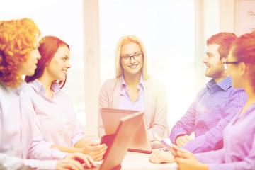 smiling team with laptop and table pc computers