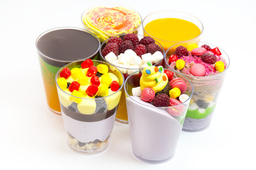 dessert in plastic cups cream with fruit and pastries and mousse