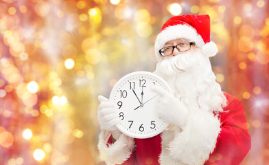 man in costume of santa claus with clock