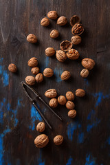 Group of ripe walnuts Nutcracker. Dark wood background. Top view