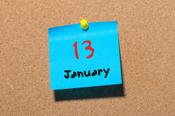 January 13th. Day 13 of month, Calendar on cork notice board. Winter time. Empty space for text