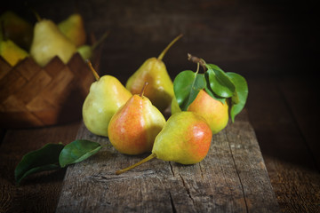 Ripe yellow pears lying on a wooden serface