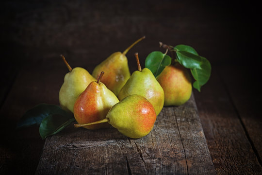 Ripe yellow pears lying on a wooden serface