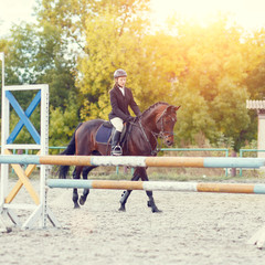Young horse rider girl on equestrian competition