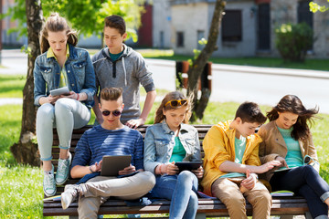group of students with tablet pc at school yard