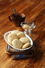 Sesame Cookies in white vase on wooden background.