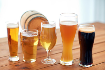 close up of different beers in glasses on table