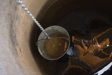 Pulling water from a well with a bucket